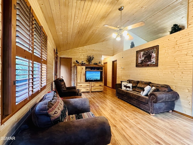 living room featuring wood walls, high vaulted ceiling, light hardwood / wood-style flooring, ceiling fan, and wood ceiling