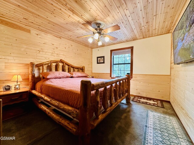 carpeted bedroom with wood walls, ceiling fan, and wooden ceiling