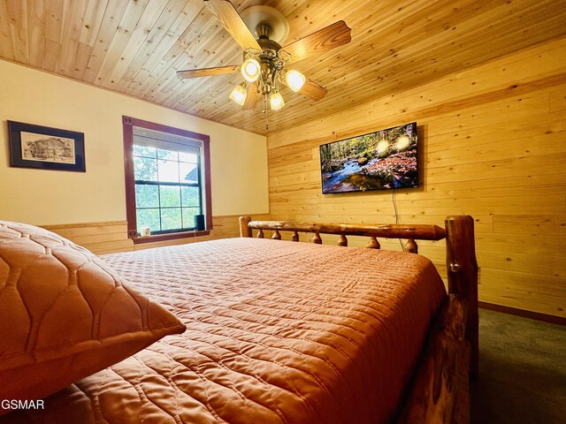 bedroom with carpet, wooden ceiling, ceiling fan, and wooden walls