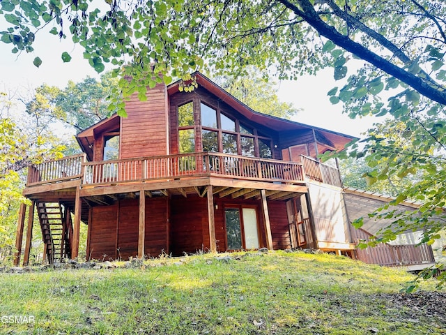 rear view of property with a wooden deck