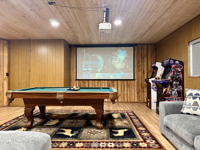 playroom with light hardwood / wood-style floors, billiards, and wood walls