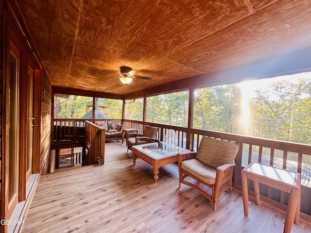 sunroom with ceiling fan and wooden ceiling