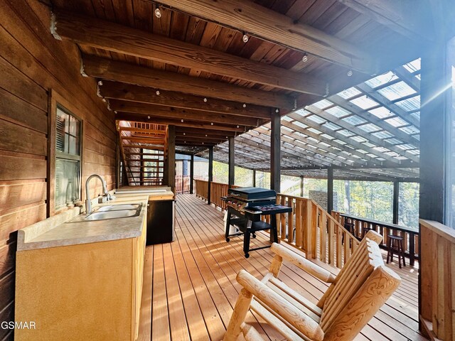 wooden deck featuring sink and grilling area