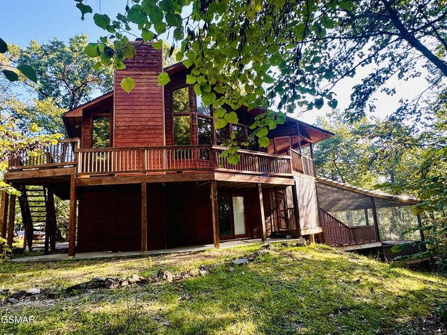 back of house featuring a wooden deck