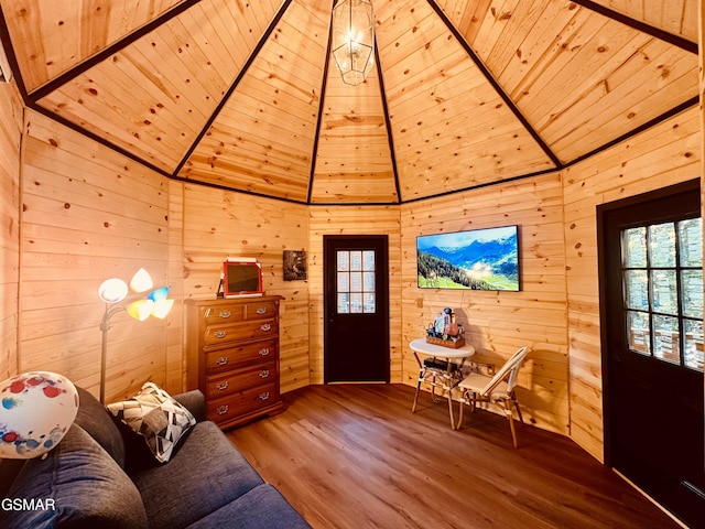 unfurnished living room with wood walls, hardwood / wood-style floors, and wooden ceiling