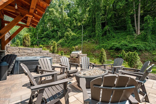 706 Kelly St, Gatlinburg, TN 37738 - view of patio with an outdoor fire pit, area for grilling, and a view of trees