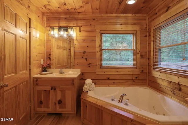 bathroom with wood walls, wooden ceiling, and a wealth of natural light