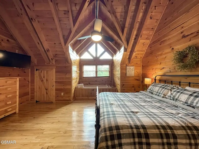 unfurnished bedroom featuring wood walls, vaulted ceiling with beams, ceiling fan, light wood-type flooring, and wood ceiling