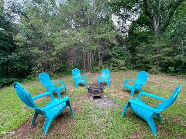 view of jungle gym featuring a yard and a fire pit