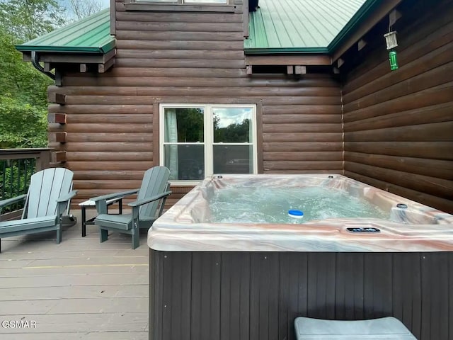 wooden terrace with a hot tub