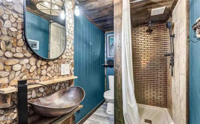 2379 Headrick Lead, Sevierville, TN 37862 - bathroom with wood finished floors, toilet, and a tile shower