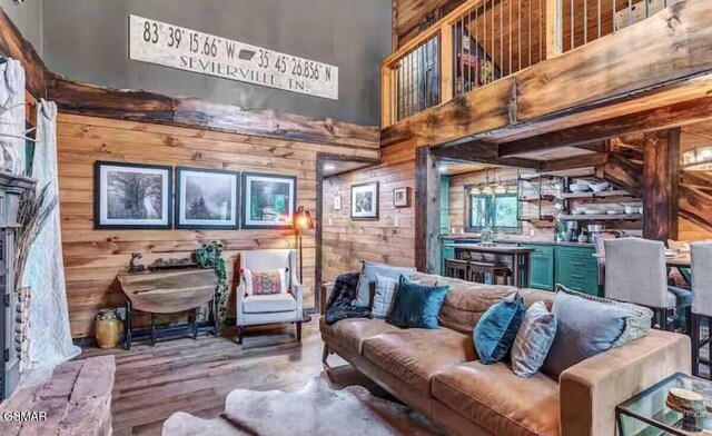 2379 Headrick Lead, Sevierville, TN 37862 - living room with wood walls, a towering ceiling, and wood finished floors
