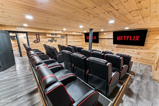 home theater room with recessed lighting, wood ceiling, wood walls, and wood finished floors