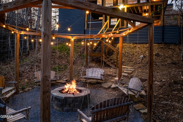 view of patio featuring a fire pit and stairs