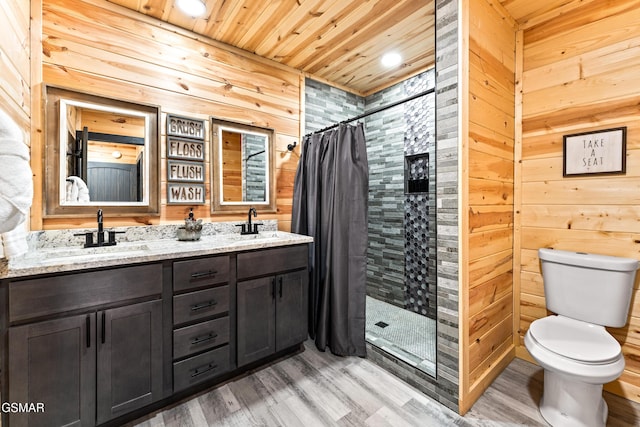bathroom with a stall shower, wood finished floors, a sink, wooden ceiling, and toilet