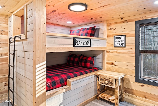 bedroom with recessed lighting, wooden ceiling, wood walls, and wood finished floors