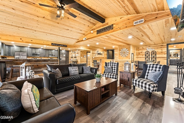 living room featuring visible vents, wood finished floors, ceiling fan, vaulted ceiling with beams, and wood ceiling