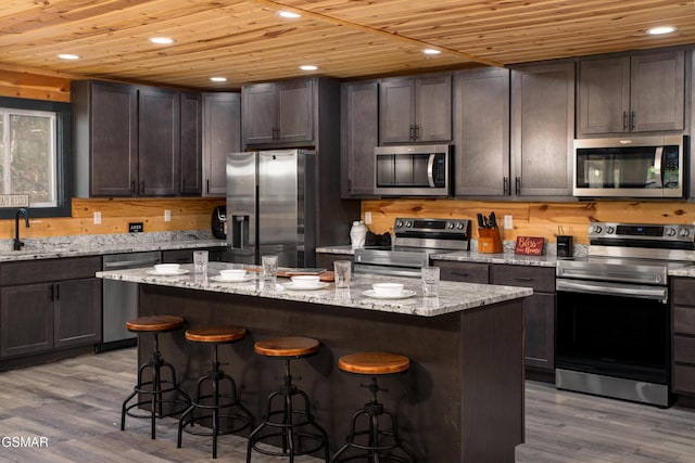 kitchen featuring a sink, dark brown cabinetry, wooden ceiling, and stainless steel appliances
