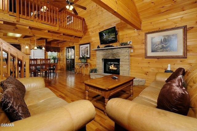 448 Silver Maple Ln, Gatlinburg, TN 37738 - living area with wood finished floors, wood walls, a fireplace, and ceiling fan