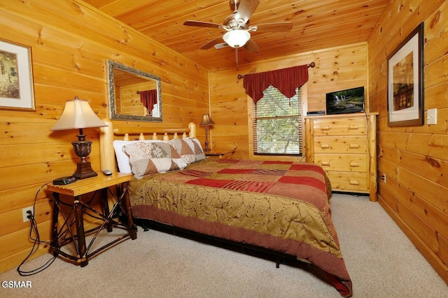 bedroom featuring carpet, wooden walls, ceiling fan, and wooden ceiling