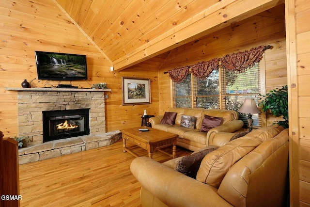448 Silver Maple Ln, Gatlinburg, TN 37738 - living room with wood finished floors, wood ceiling, wood walls, a stone fireplace, and vaulted ceiling