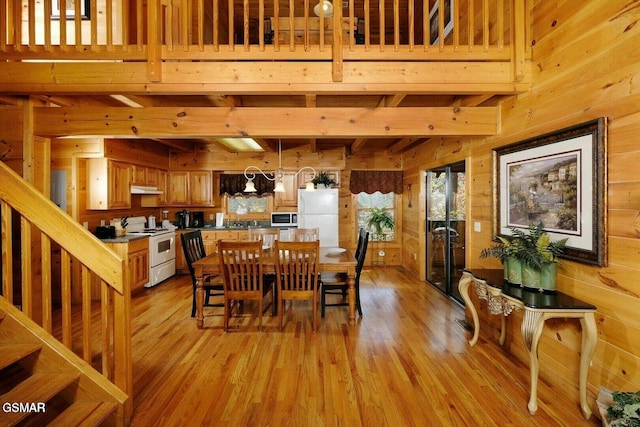 448 Silver Maple Ln, Gatlinburg, TN 37738 - dining room with wooden walls, light wood-type flooring, and beam ceiling
