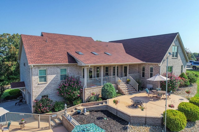 back of house featuring a patio area and an outdoor fire pit