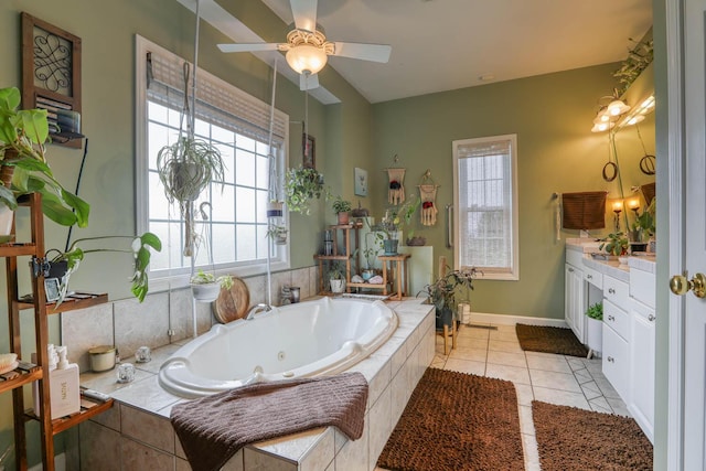 bathroom featuring tile patterned floors, tiled bath, ceiling fan, and vanity