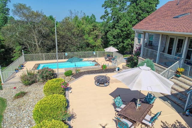 view of pool featuring a patio and an outdoor fire pit