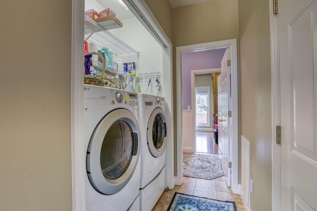 laundry area with light tile patterned flooring and independent washer and dryer