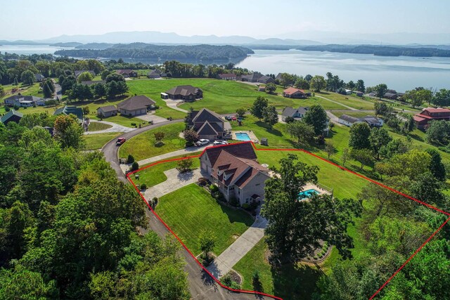 birds eye view of property with a water and mountain view