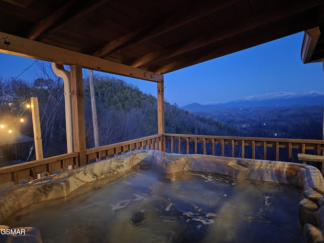 view of patio / terrace with a view of trees and a mountain view