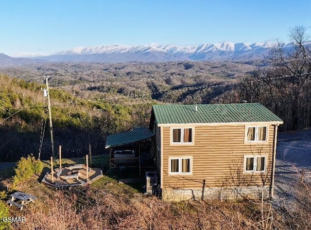 exterior space featuring metal roof, a carport, and a mountain view