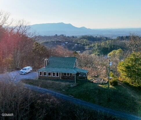 aerial view with a view of trees and a mountain view