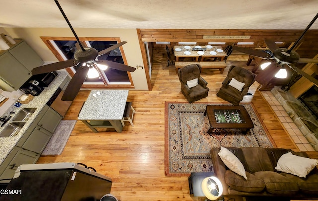 living room featuring wood finished floors and ceiling fan