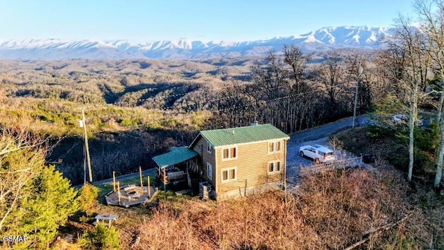 birds eye view of property with a forest view and a mountain view