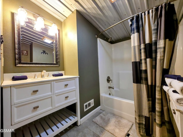 full bathroom with visible vents, shower / bath combo with shower curtain, tile patterned flooring, baseboards, and vanity