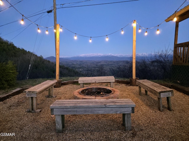 view of property's community with a mountain view and a fire pit