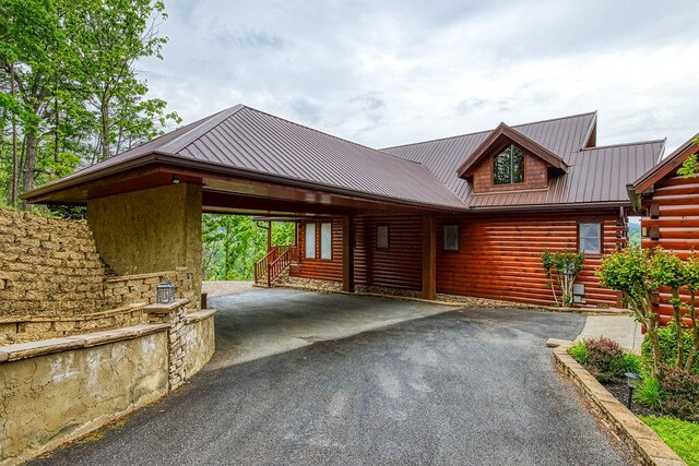 log home featuring a carport