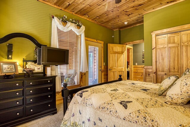 carpeted bedroom with a closet and wooden ceiling