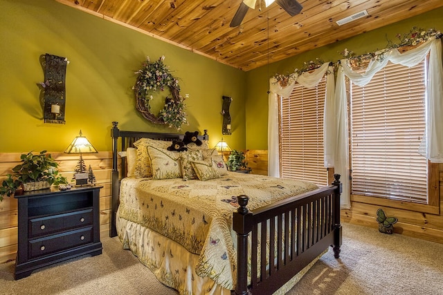 bedroom with carpet flooring, ceiling fan, wooden ceiling, and crown molding