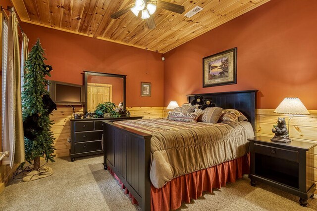 carpeted bedroom with crown molding, ceiling fan, lofted ceiling, and wood ceiling