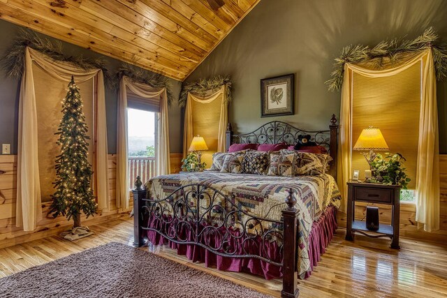 bedroom with wood ceiling, vaulted ceiling, and light hardwood / wood-style floors