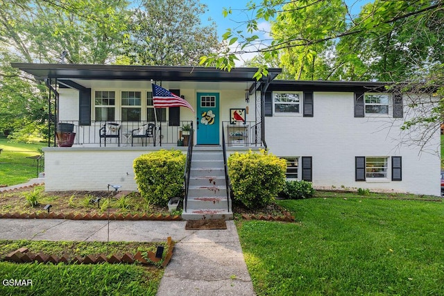 4325 San Juan Ln, Knoxville, TN 37914 - view of front of house with a front yard, a porch, brick siding, and stairway