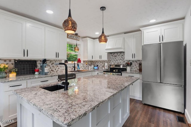 4325 San Juan Ln, Knoxville, TN 37914 - kitchen featuring appliances with stainless steel finishes, a sink, custom range hood, white cabinetry, and dark wood-type flooring