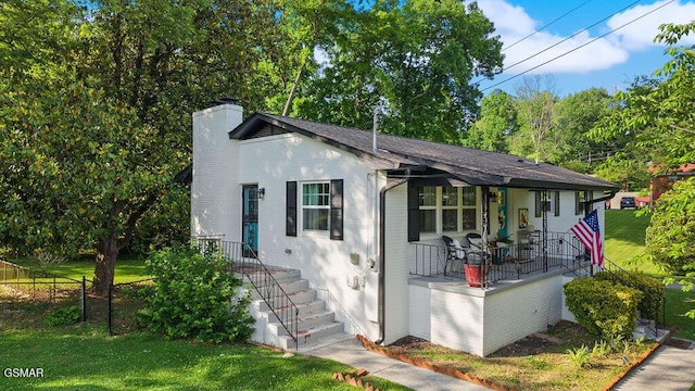 4325 San Juan Ln, Knoxville, TN 37914 - bungalow-style house featuring a chimney, brick siding, covered porch, and roof with shingles