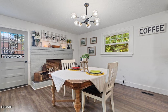 4325 San Juan Ln, Knoxville, TN 37914 - dining room featuring plenty of natural light, dark wood-style floors, baseboards, a chandelier, and a textured ceiling