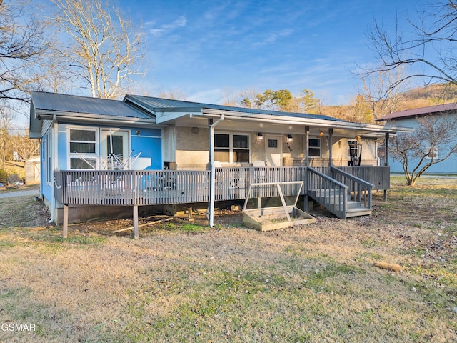 exterior space featuring covered porch and a front yard