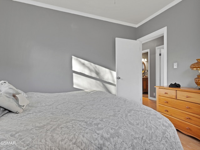 bedroom featuring light hardwood / wood-style flooring and ornamental molding