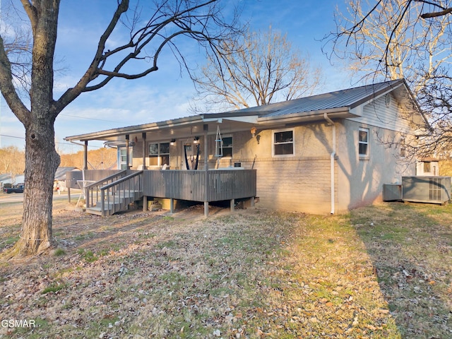 back of property with a wooden deck and central air condition unit